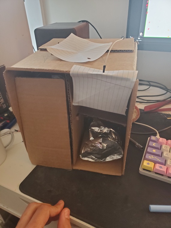A cardboard box prototype built during a session.