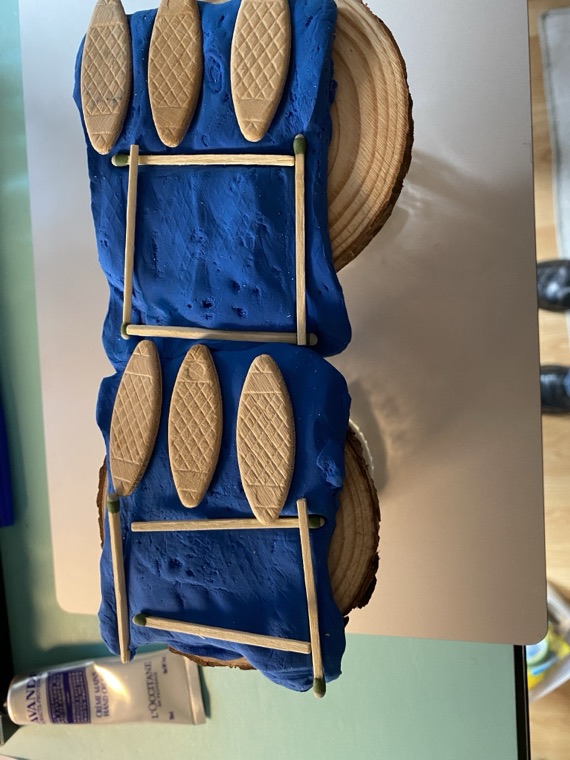 A prototype built from cardboard and blue fabric.